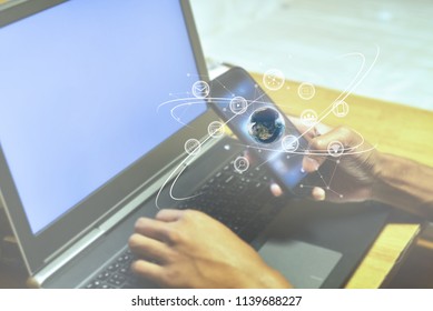Businessman using laptop and smart phone with social multi media icon network technology concept - Shutterstock ID 1139688227