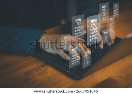 Businessman using laptop with virtual interface of online store management system, illustrating e-commerce analytics, digital marketing, inventory control, and business technology innovation concept.