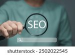 Businessman using magnifying glass focus to SEO icon to analyze SEO search engine optimization for promoting ranking traffic on website and optimizing your website to rank in search engines.