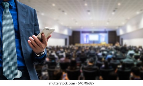 businessman using the mobile phone, business people forum Meeting Conference Training Learning Coaching Concept, Blurred background - Powered by Shutterstock