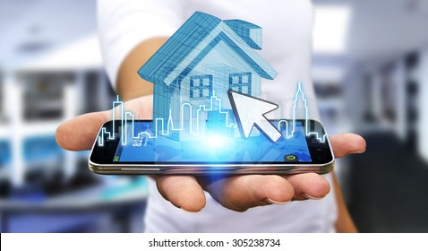 Businessman using mobile phone with digital house and city