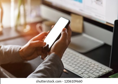 Businessman Using Mobile Phone On Desk, Smart Phone Showing Blank Screen For Montage.