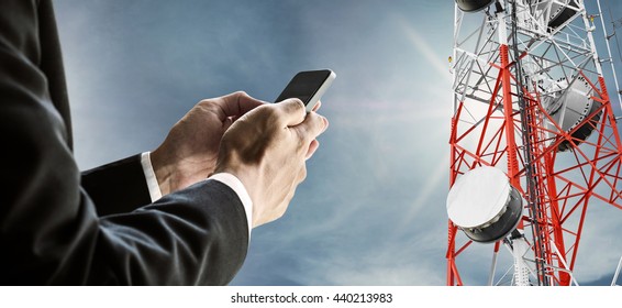 Businessman Using Mobile Phone, With Satellite Dish Telecom Network On Telecommunication Tower On Blue Sky With Sunshine