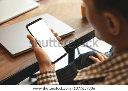 businessman using mobile phone with white mockup blank copy space for your text message in cafe .Vintage tone.Selective focus