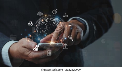 Businessman using mobile smartphone shows the future world of the metaverse with internet technology icons, Digital Marketing, Financial and banking, Metaverse, Digital link tech, Big data concept. - Powered by Shutterstock