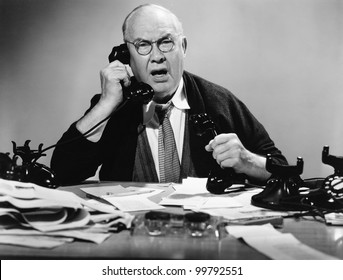 Businessman Using Multiple Phones