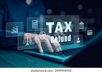 Businessman using a pen to write a notebook with TAX REFUND and refund tax of duty taxation business, graphs and chart being demonstrated on the screen media,  tablet pc and selecting tax refund.