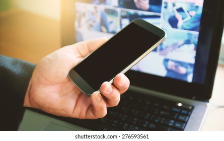 Businessman using smart phone and computer. - Shutterstock ID 276593561
