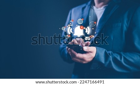 Businessman using smart phone with virtual bell ringing for application notification alert concept. social media and internet network notification alert, email, telephone, chat, shopping online.