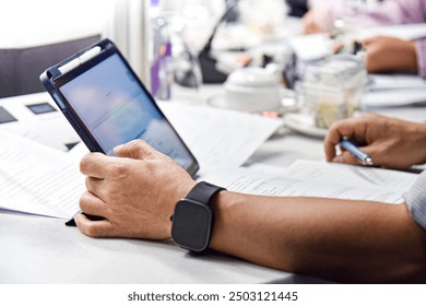 Businessman using smart watch and digital tablet in the office. Business concept. - Powered by Shutterstock