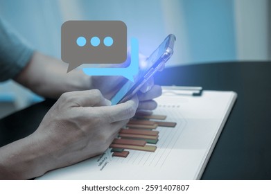 Businessman using smartphone analyzing trading graph data User playing Social media technology, Social media marketing concept using smartphone typing, chatting conversation in chat box icons pop up