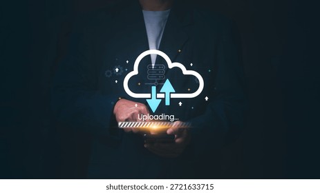 Businessman using a smartphone for cloud computing data transfer with uploading icons, Concept of digital storage, networking technology, big data backup, and global server synchronization.