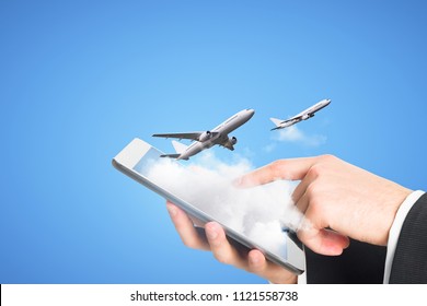 Businessman Using Smartphone With Clouds And Airplane On Blue Background. Online Ticket Purchase Concept 