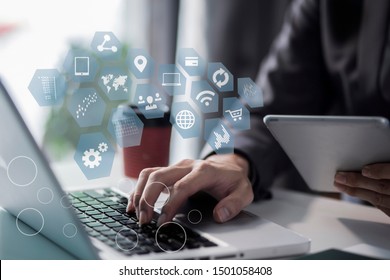 Businessman using a smartphone with computer keyboard at office on digital interface. innovation, icon and media information on network connection. - Shutterstock ID 1501058408