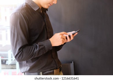 Businessman using smartphone with cropped shot photo.