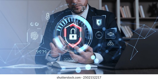 Businessman using smartphone with digital security icons overlay in modern office. Represents data protection and cybersecurity concept - Powered by Shutterstock