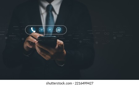 Businessman using  smartphone to display contact to send information to customers, concept of using internet technology to contact customers, customer service, hotline, contact us, web page or e-mail. - Shutterstock ID 2216499427