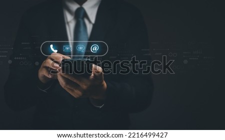 Businessman using  smartphone to display contact to send information to customers, concept of using internet technology to contact customers, customer service, hotline, contact us, web page or e-mail.