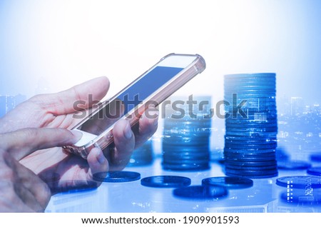 businessman using smartphone with double exposure of coin stacking background for technology digital online financial concept online trading and cryptocurrency investment.