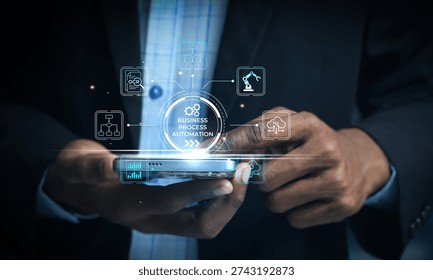 Businessman using smartphone interface to control automated business processes with icons representing technology