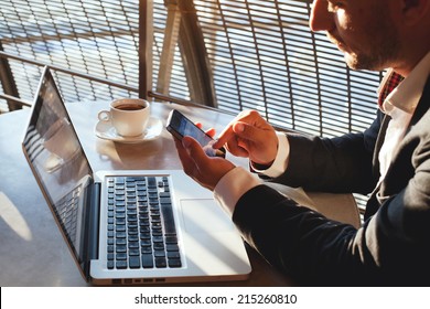 Businessman Using Smartphone And Laptop