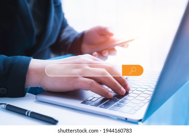 Businessman using the smartphone  and laptop in office with  virtual screen Searching Browsing Internet Data Information Networking Concept - Shutterstock ID 1944160783