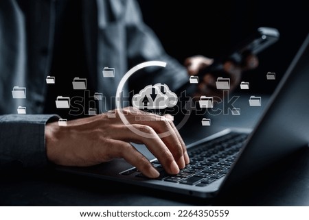 Businessman using smartphone and laptop uploading to cloud computing to download and loading data information and upload on system network application. Technology transformation concept	
