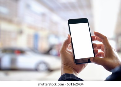 Businessman using smartphone over blurred garage car service center background. For Graphic design montage. - Powered by Shutterstock