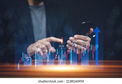 Businessman using smartphone or Tablet trading online in bitcoin forex stock market and other ETH NFT token cryptocurrency
