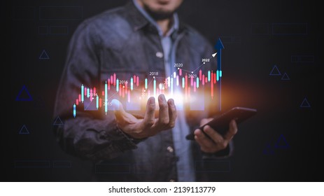 Businessman using smartphone or Tablet trading online in bitcoin forex stock market and other ETH NFT token cryptocurrency - Shutterstock ID 2139113779