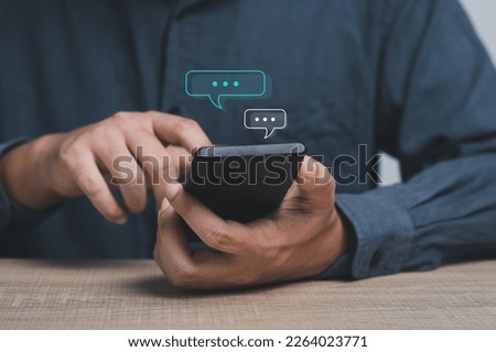 businessman using smartphone typing Live chat chatting and social network concepts, chatting conversation working on mobile phone in chat box icons pop up. Social media marketing technology concept.