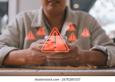 businessman using smartphone with virtual triangle caution sign, investment risk management strategy Category Business cyber security