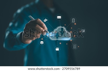 Businessman using stylus to interact with cloud computing interface for data upload and download. Concept for cloud technology, data storage, remote access, digital transformation, and networking.