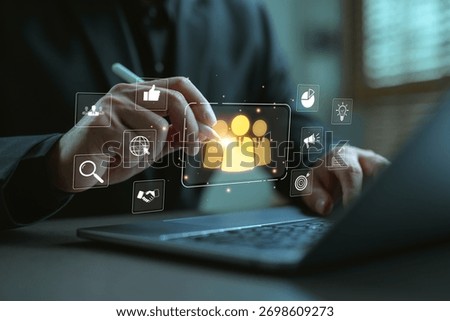 Businessman using stylus to interact with virtual human resource interface on laptop, representing HR management, employee analytics, digital recruitment, and workforce optimization strategy.