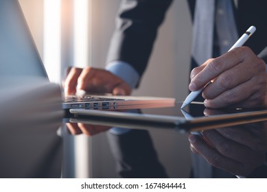 Businessman Using Stylus Pen Signing Contract On Digital Tablet Working On Laptop Computer In Modern Office, Electronic Signature. Business Man Taking Note On Touchpad, Business And Technology Concept