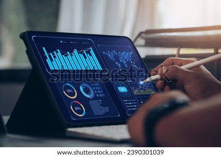 Businessman using tablet Analytics Data KPI Dashboard Tech with charts, metrics, and KPI to analyze performance and create insight reports for operations management.Data mining.Data analysis.Ai