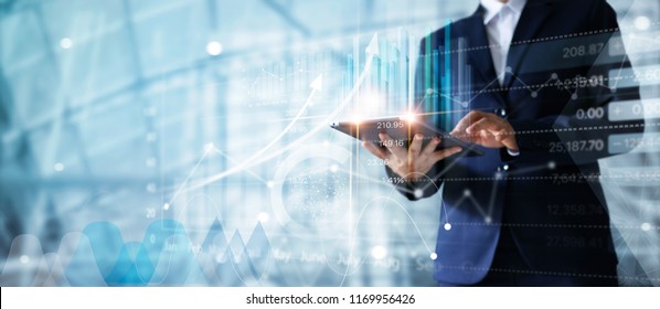 Businessman using tablet analyzing sales data and economic growth graph chart.  Business strategy. Abstract icon. Digital marketing. - Shutterstock ID 1169956426