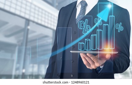 Businessman using tablet analyzing sales data and economic growth graph chart.  Business strategy. Abstract icon. Digital marketing.