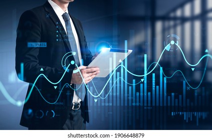 Businessman using tablet with business report hologram. Business and financial success concept. double exposure. Forex Chart - Powered by Shutterstock