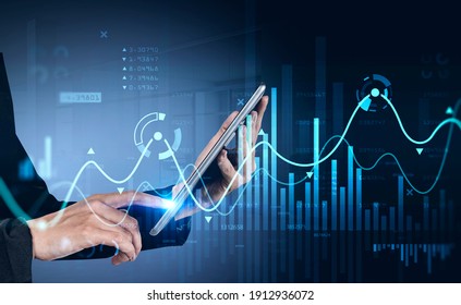 Businessman using tablet with business report hologram. Business and financial success concept. double exposure. Forex Chart