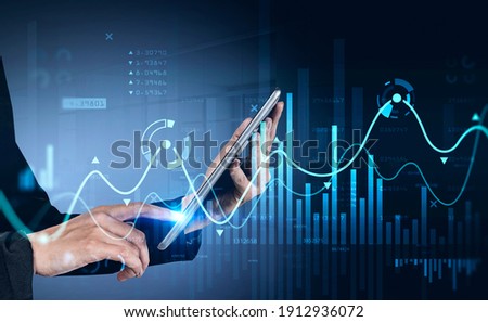 Businessman using tablet with business report hologram. Business and financial success concept. double exposure. Forex Chart
