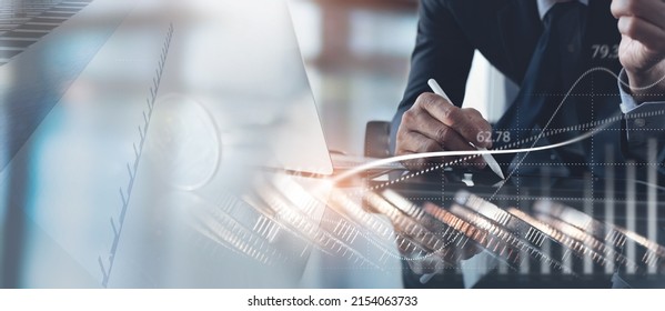 Businessman using tablet computer analyzing business data with economic growth, financial graph chart report and coins, double exposure. Business strategy, finance and investment concept