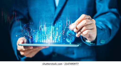 Businessman using tablet computer and pointing a growing virtual diagram, invest, achievement, planning analyze and strategy, marketing. Stock market progress or success
