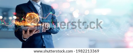 
Businessman using tablet to connected on global network and gold bitcoin coin in fire and growth of business graph, Financial, Stock market, Cryptocurrency and investment.