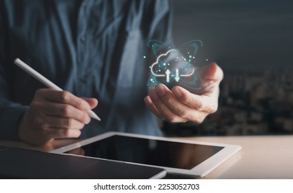 A businessman is using a tablet and has a cloud computing diagram nearby. cloud computing. saving of data. Concept for networking and internet services.