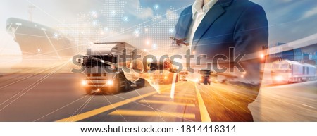 Businessman using tablet on logistic network distribution and smart transportation and networking intelligent logistics of truck and train container cargo ship, Logistic import export and industry. 