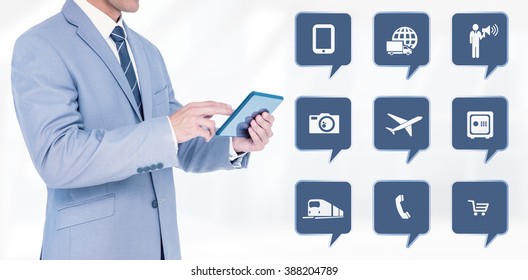 Businessman using tablet pc against modern room overlooking city - Powered by Shutterstock