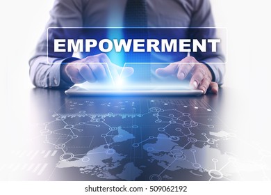 Businessman is using tablet pc, pressing on virtual screen and selecting empowerment.