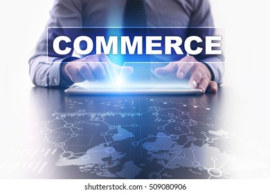 Businessman is using tablet pc, pressing on virtual screen and selecting commerce.