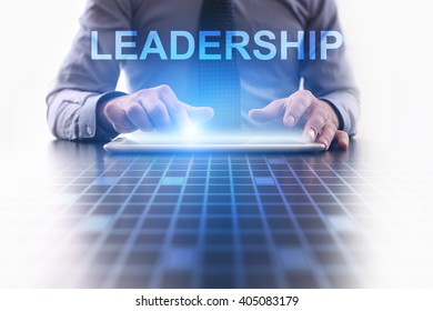Businessman using tablet pc and select Leadership.